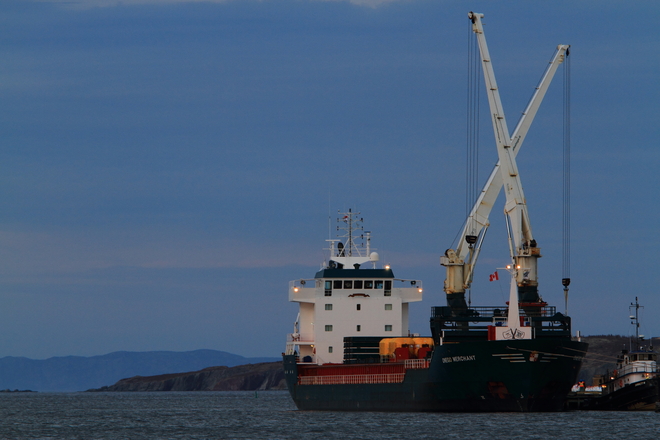 Ship unloading cargo on clear evening Bay Roberts, Newfoundland and Labrador Canada