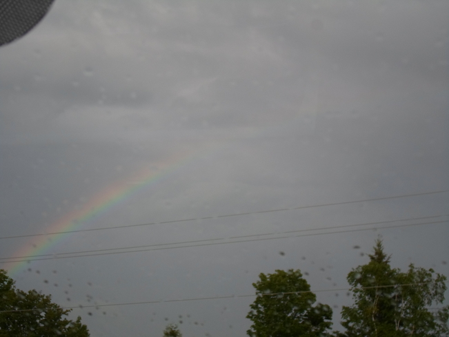 Rainbow during rain and sunshine Elliot Lake, Ontario Canada