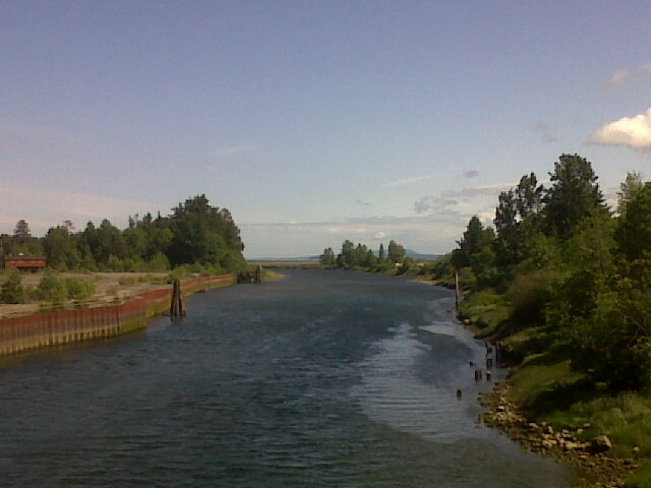 River under almost blue sky. Courtenay, British Columbia Canada