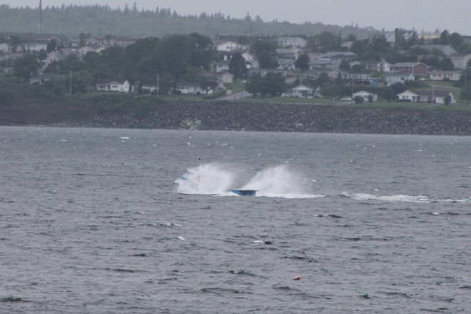Fishing boat covered in waves Sydney, Nova Scotia Canada