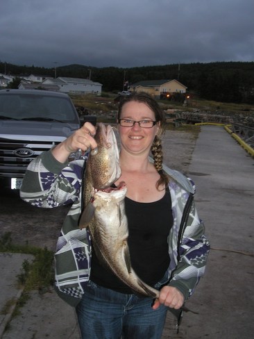 the wife showing off her cod fish she caught Whiteway, Newfoundland and Labrador Canada