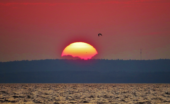 Setting sun meets thunderhead. North Bay, Ontario Canada