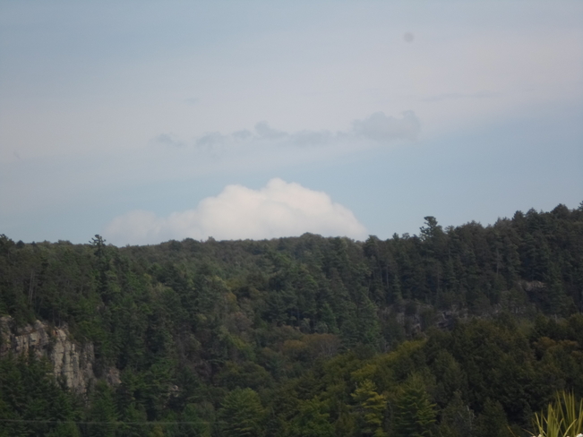 cloud resting above the trees Elliot Lake, Ontario Canada