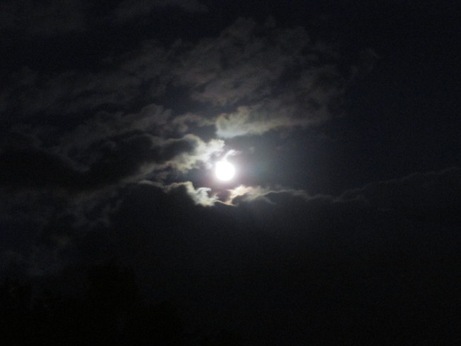 Glowing moon surrounded by clouds Riverview, New Brunswick Canada