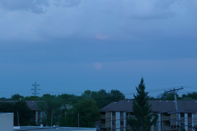 rain movin SE and moon rise Winnipeg, Manitoba Canada