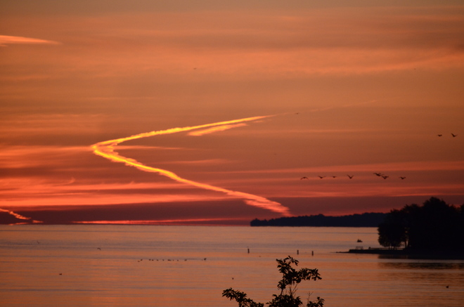 vapour trail at sunrise Barrie, Ontario Canada