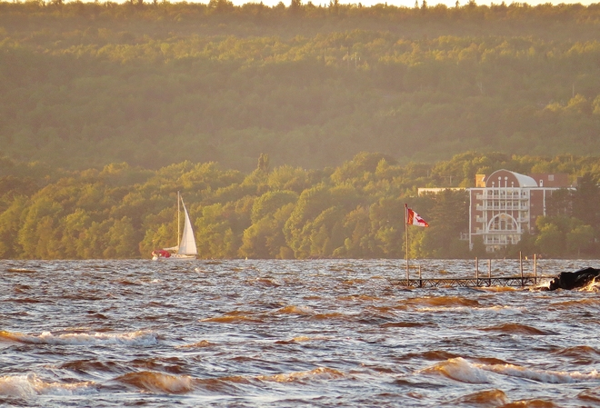Sailing on a very windy Lake Nipissing at sunset. North Bay, Ontario Canada