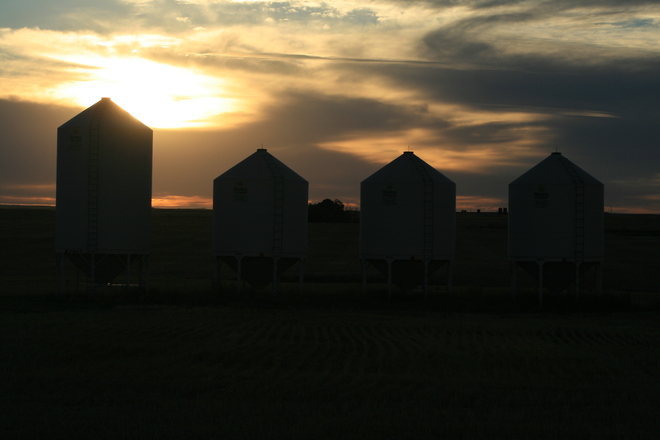 sunset and grain bins Reward, Saskatchewan Canada