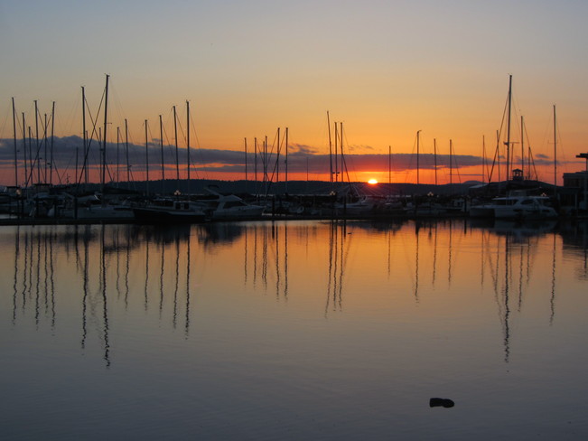 Sun rises behind Port Sidney Marina Sidney, British Columbia Canada