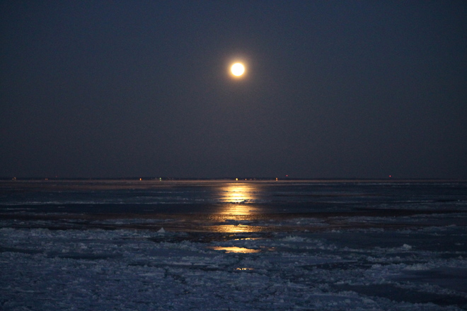 Moon over the icy water Cap-Pele, New Brunswick Canada
