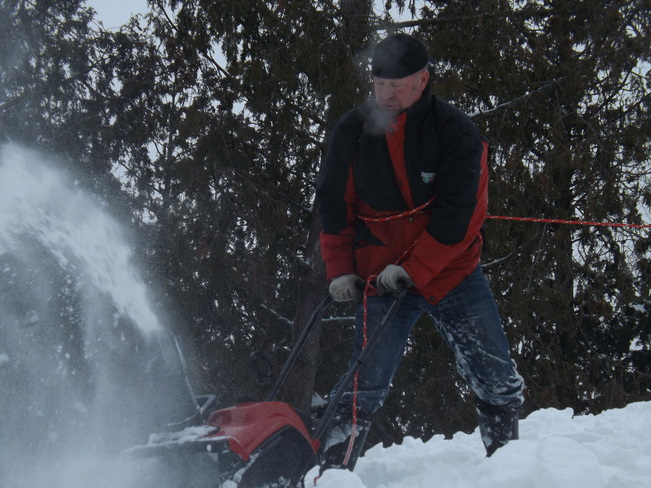 Cleaning snow off the roof Dunchurch, Ontario Canada