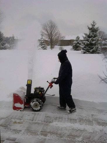 Cleaning-up overnight snowfall in preparation for Sunday snowfall Bayfield, Ontario Canada