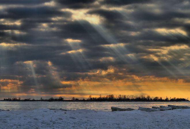 Crepuscular rays over High Bluff Island, Presqu'ile Brighton, Ontario Canada