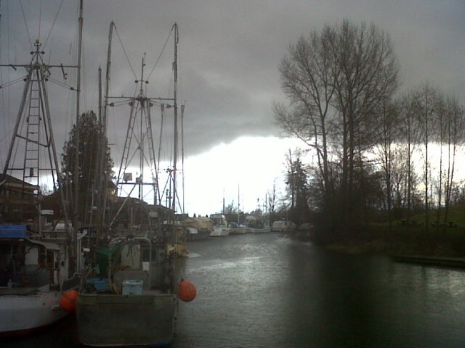 Boats under clouds and sun Comox Valley, British Columbia Canada