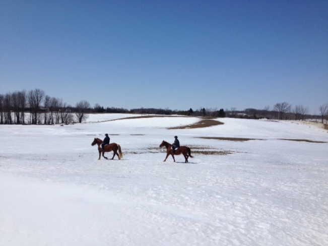 Riding the fields as the snow melts. Ayton, Ontario Canada