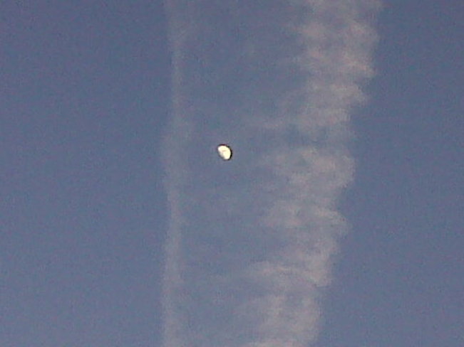 Moon in trail of cloud. Comox Valley, British Columbia Canada