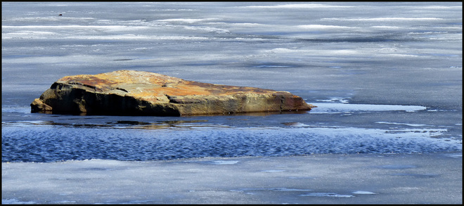 Sheriff Creek, pond rock free of ice. Elliot Lake, Ontario Canada