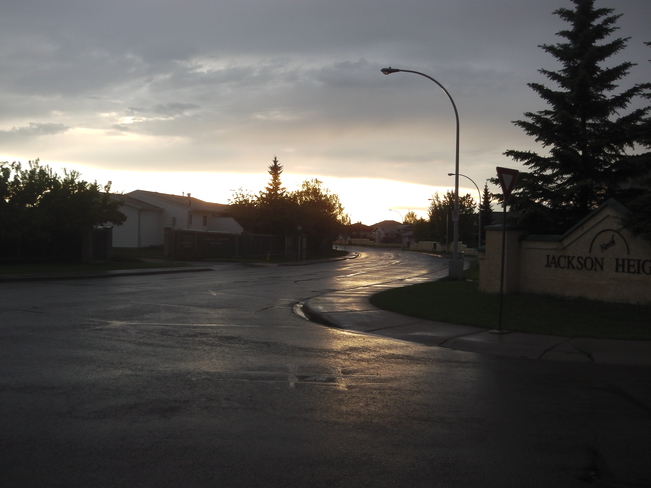 Rain is coming down and Edmonton and the sun is about to come out of the clouds. Edmonton, AB