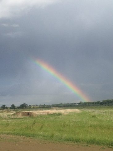 Rainbow after the storm and hail clouds Brooks, Alberta