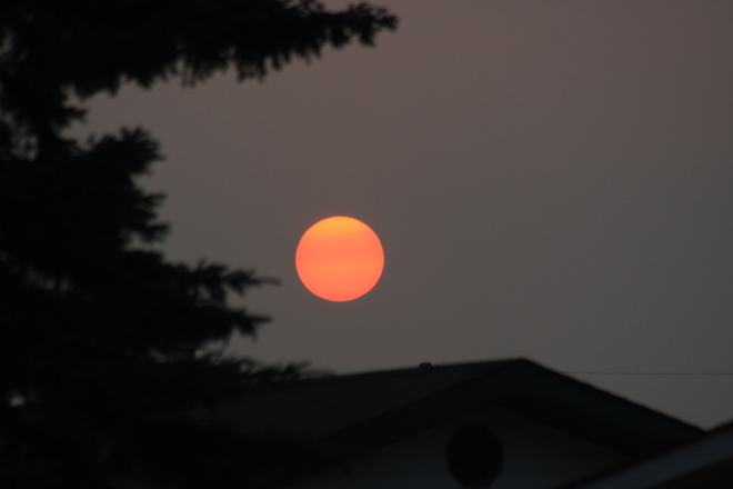 Sunset in the smoky haze and the next day a clearing shower Tofield, AB