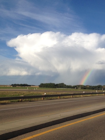 rainbow in thunderstorm Brooks, Alberta Canada