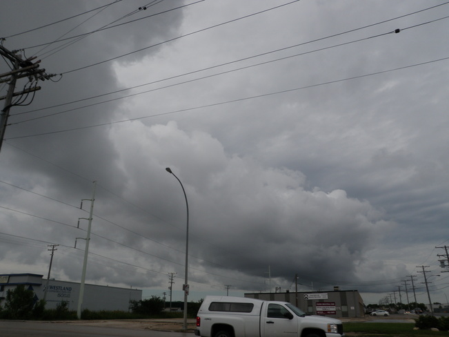 dark ominous clouds over head Winnipeg, MB