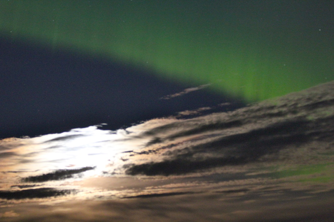 Northern lights in clouds and moon light 