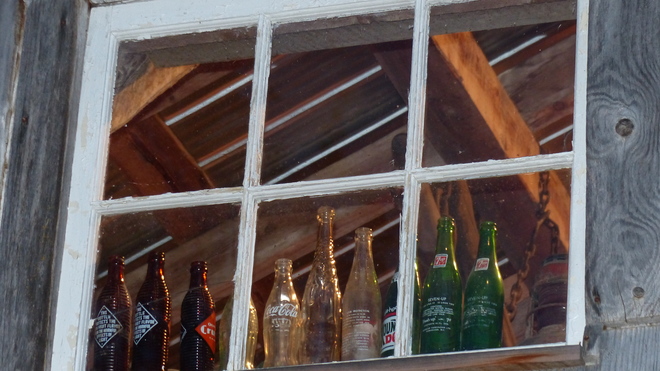 Old bottles in a barn window Grand Forks, BC