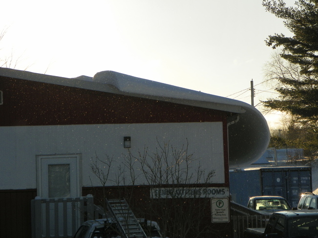 Snow sliding off roof of the Seniors' Room at the Bridgewater Memorial Arena Bridgewater, NS