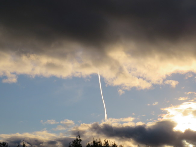 Dark clouds with airplane smoke between them!! Florence, Nova Scotia