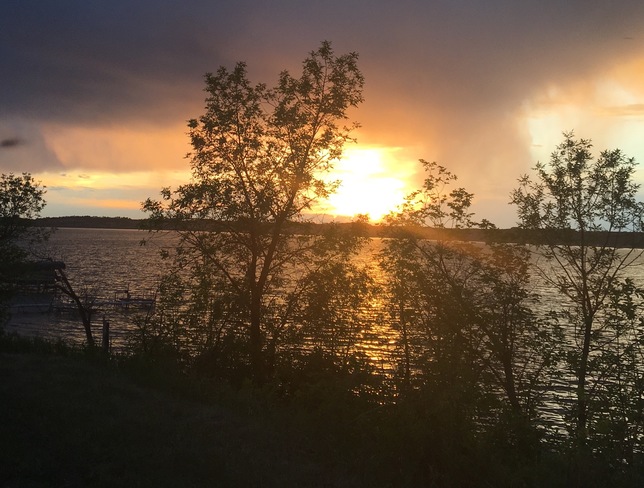 Sunset though the rain clouds over last Mountain Lake. 235 Allan Ln, Regina Beach, SK S0G 4C0, Canada