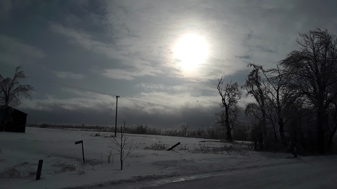 Wind turbine acting weird! Late afternoon sun over ice storm. Southgate, ON