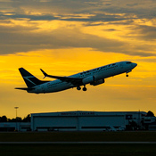 Westjet taking off into the sunset