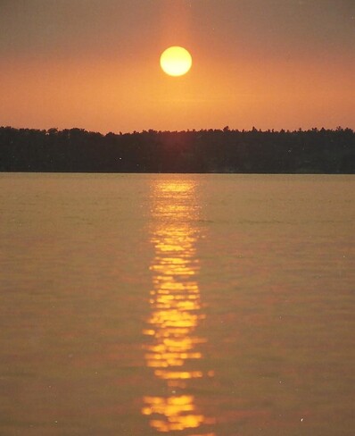 Sun setting on Kashwakamac Lake Frontenac County, ON