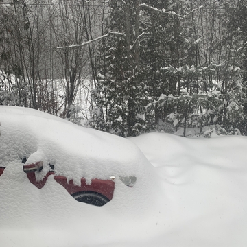 Car almost completely buried in snow