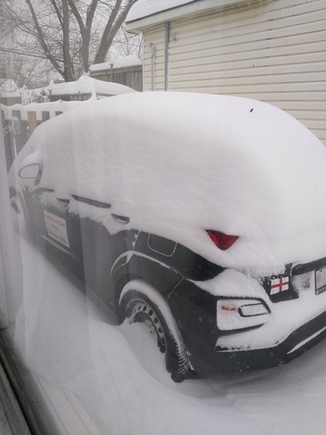 car almost buried from snowstorm. Loud bangs of lightning so loud in the night. Welland, ON