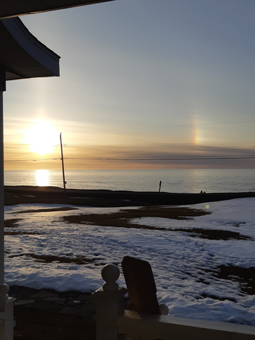 Evening sunset with a rainbow reflecting on the water, Mar. 29/23 Mainland, NL