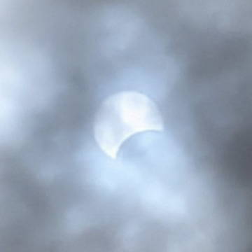 Eclipse through the Clouds