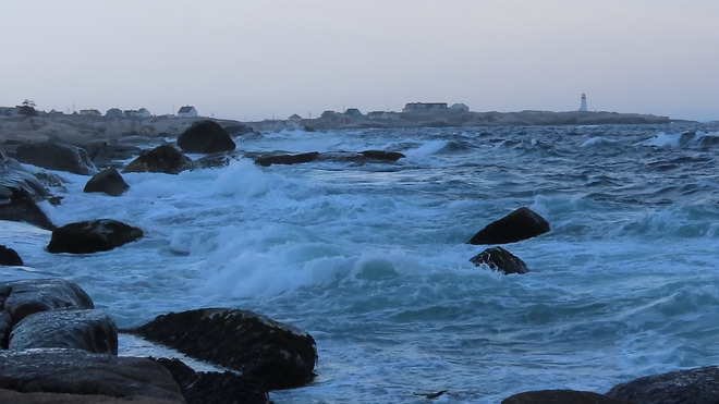 Waves crashing tonight with Peggy's Cove lighthouse in the distance. Peggys Cove, NS